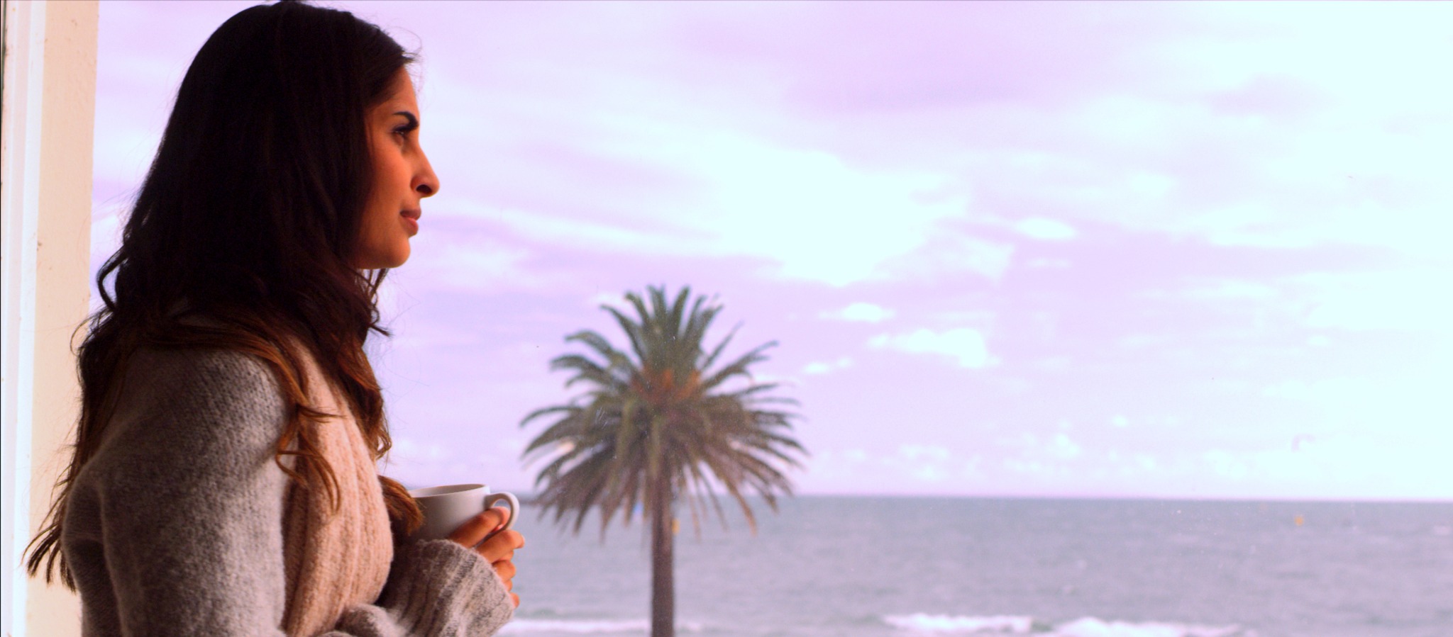 Maria looking out over the sea in a film still